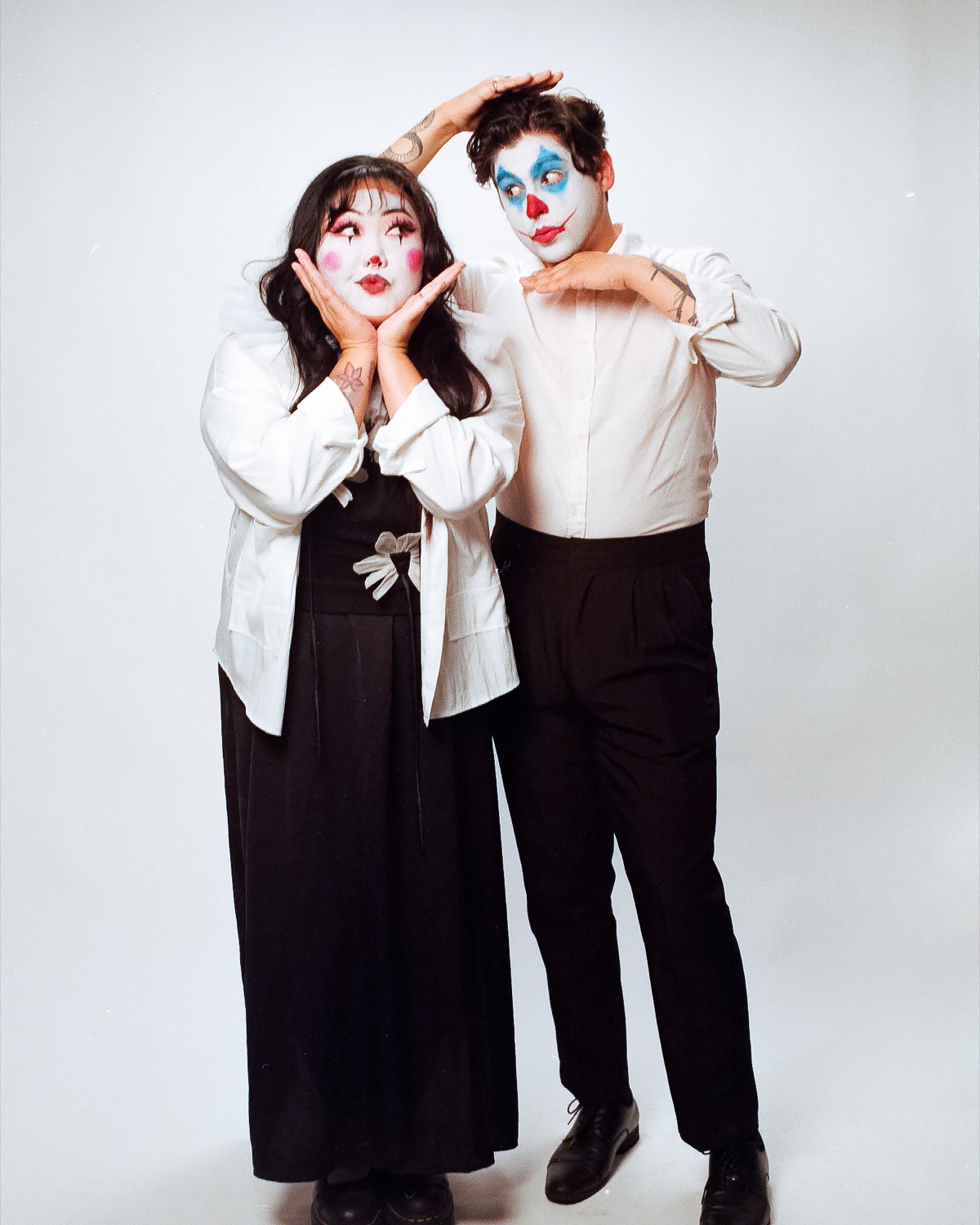 Playful couples session in matching character makeup on a white backdrop — Look Gross Studio