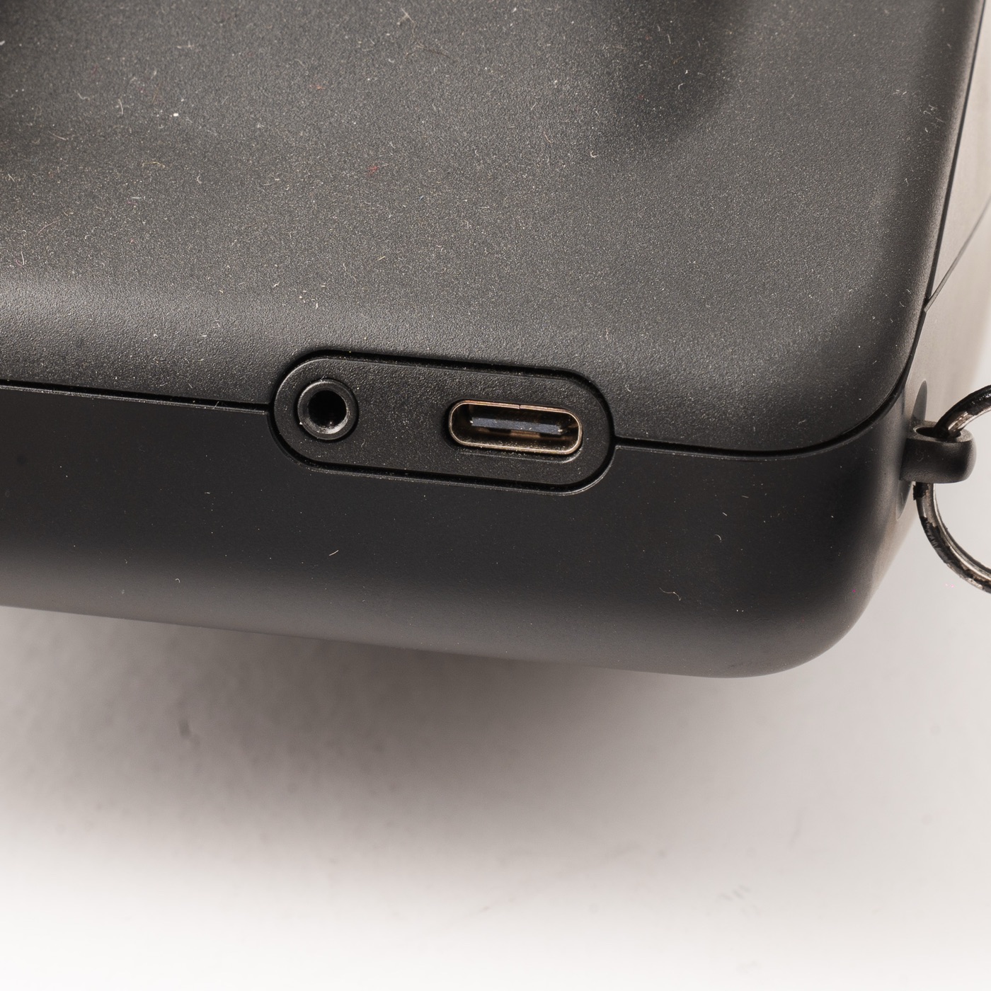 The 2.5 mm flash sync port on the bottom edge of the Polaroid I-2, next to the USB-C port