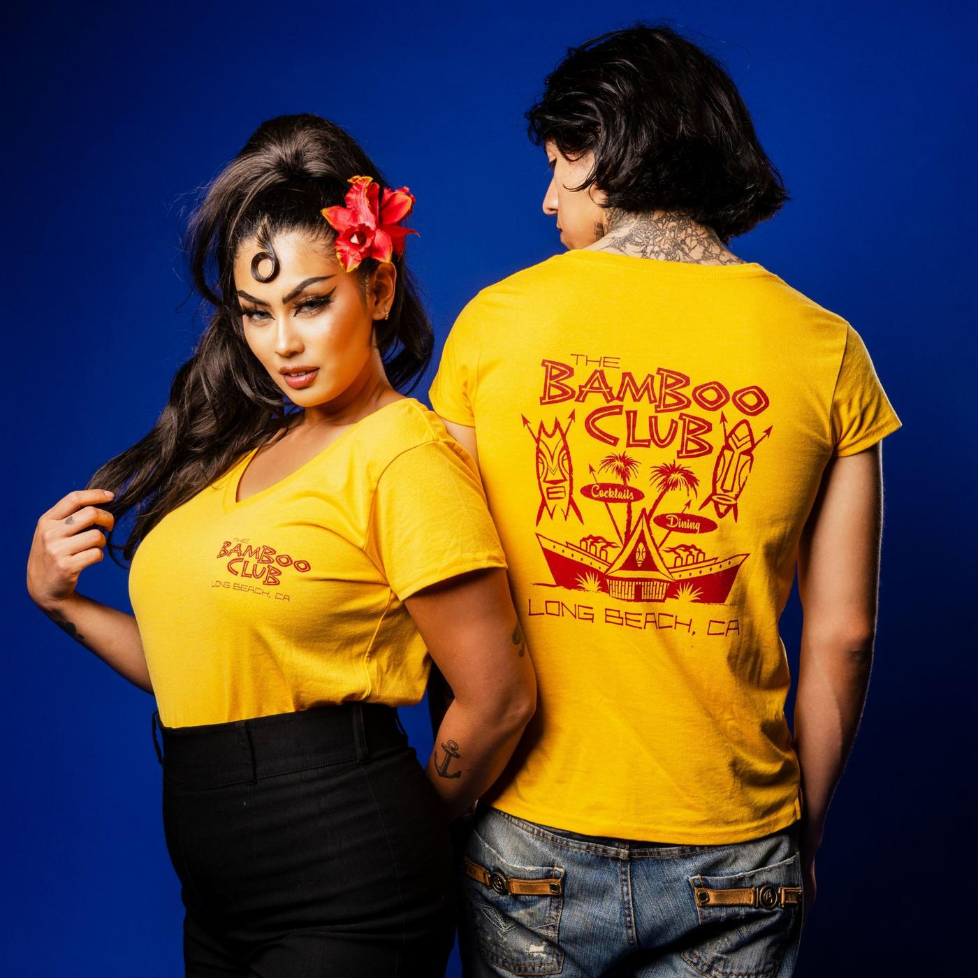 Two models in yellow Bamboo Club tees, front and back print