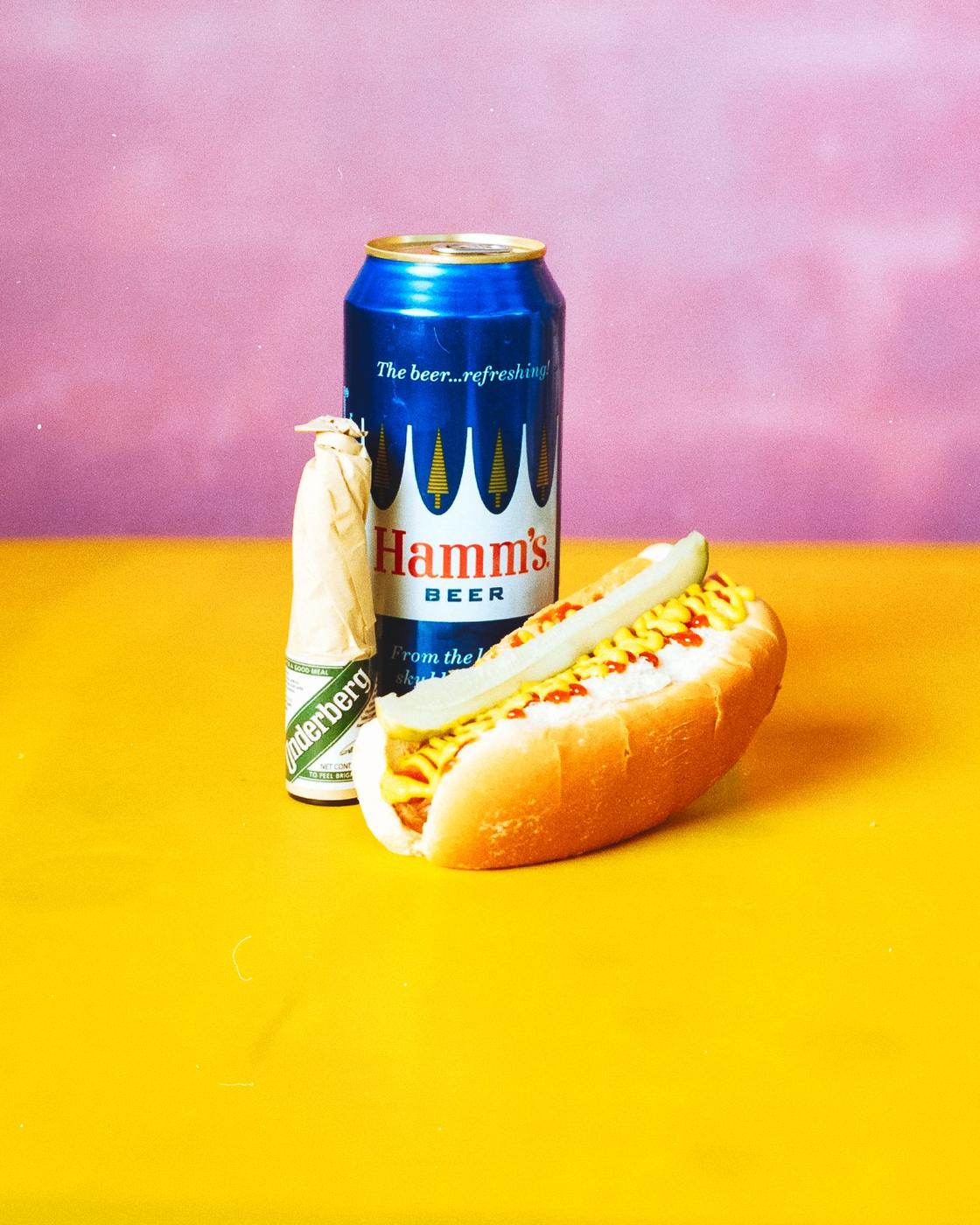 Hamm's can, Underberg and a hot dog on yellow