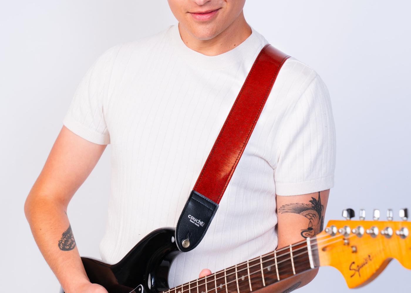 Model in a white tee with a red sparkle strap