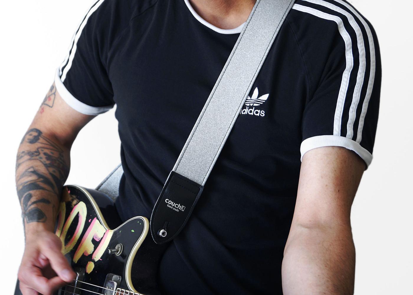 Model in a striped track tee with a silver strap