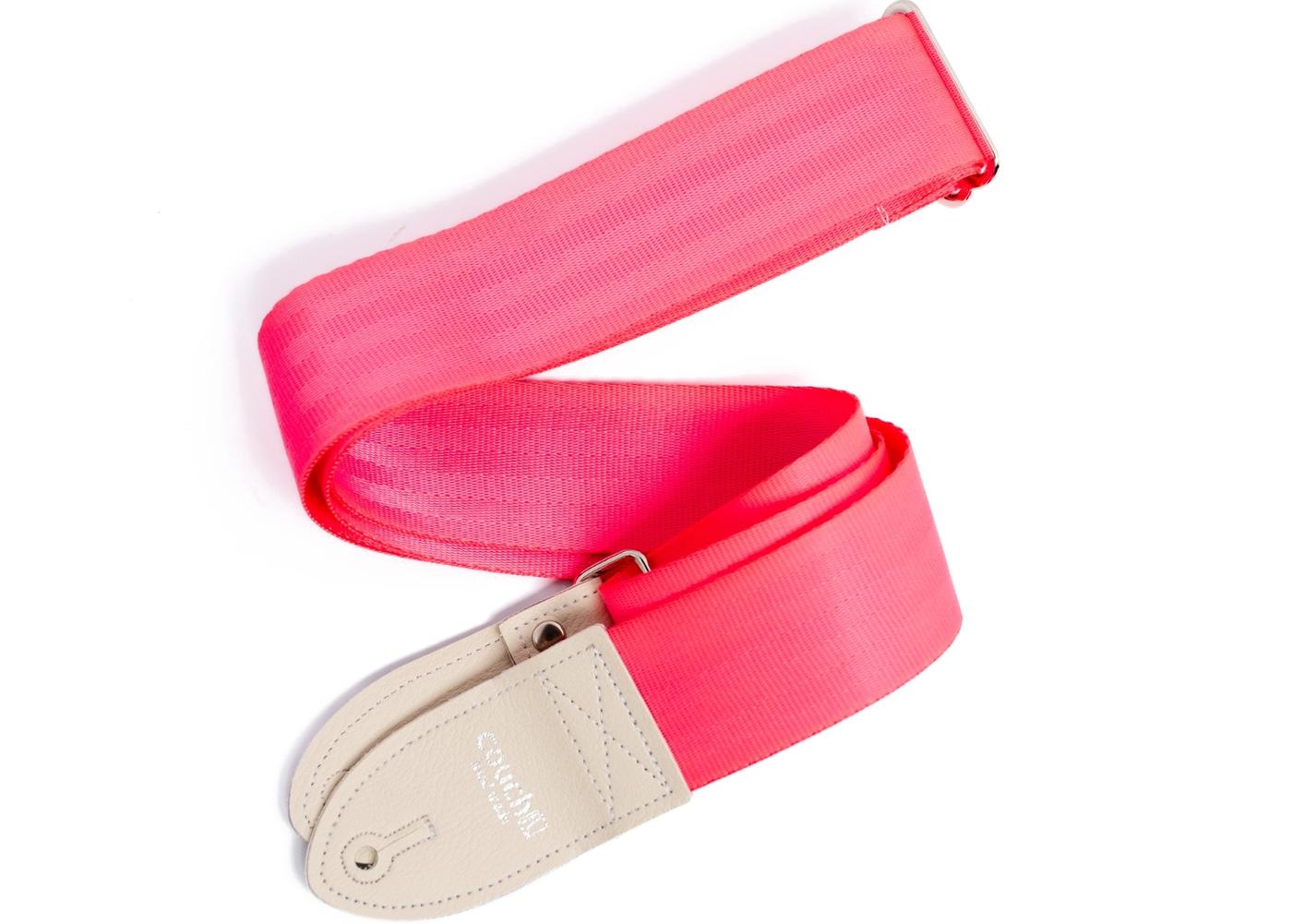 Hot pink seatbelt guitar strap on white