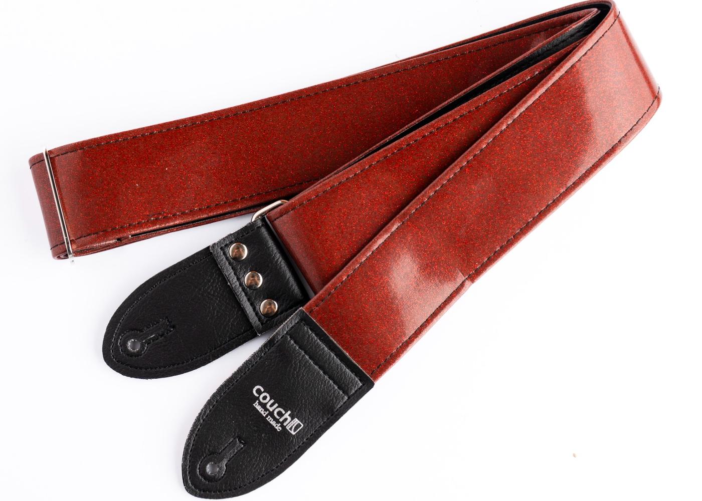 Red sparkle guitar strap on white