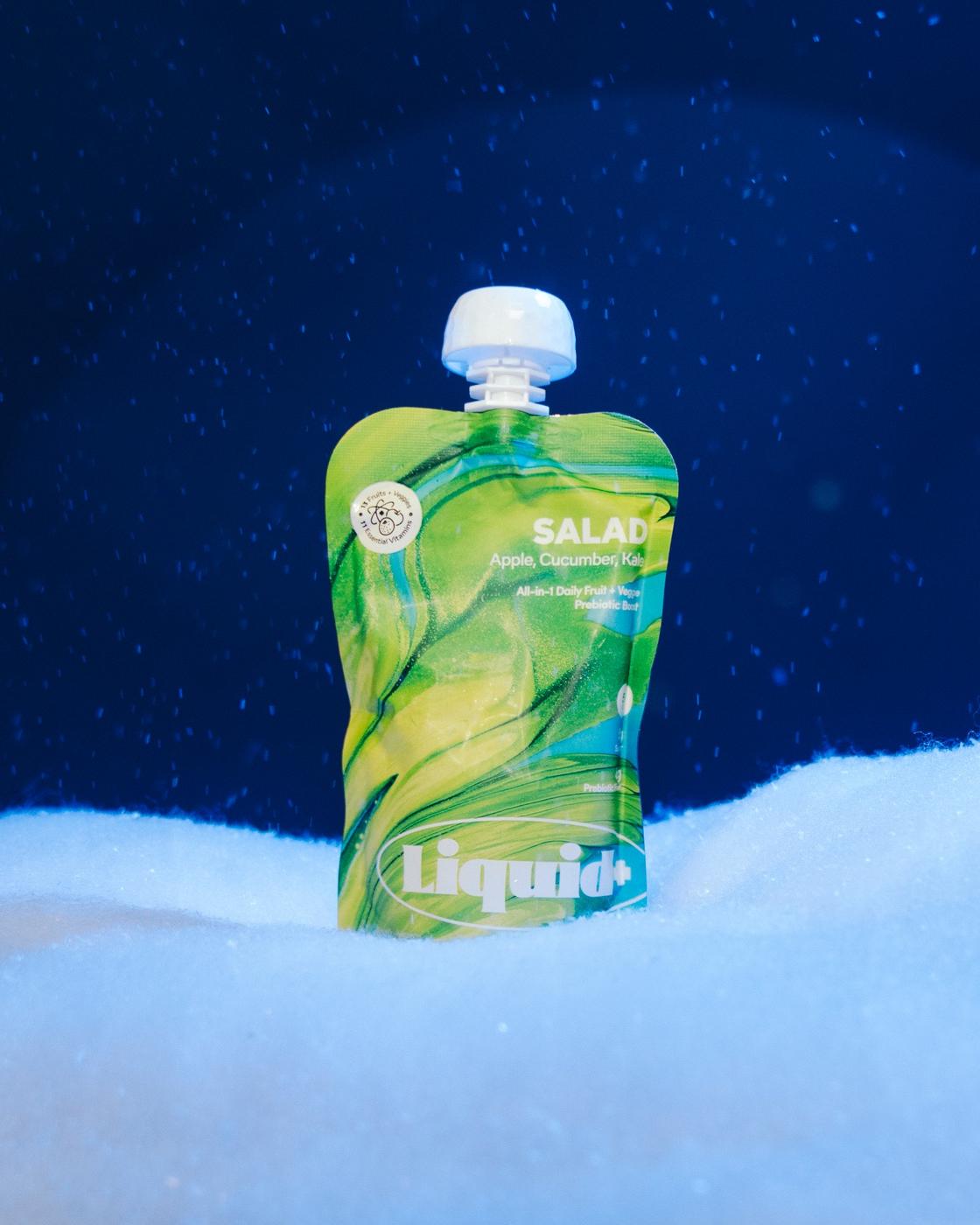 Liquid+ pouch in falling snow on navy