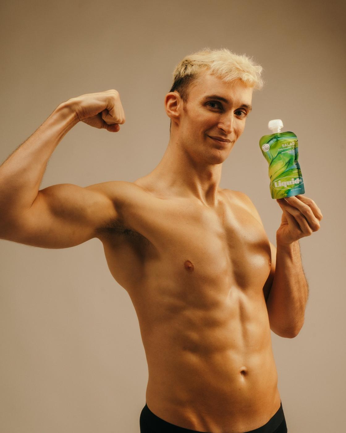 Model flexing while holding a Liquid+ pouch