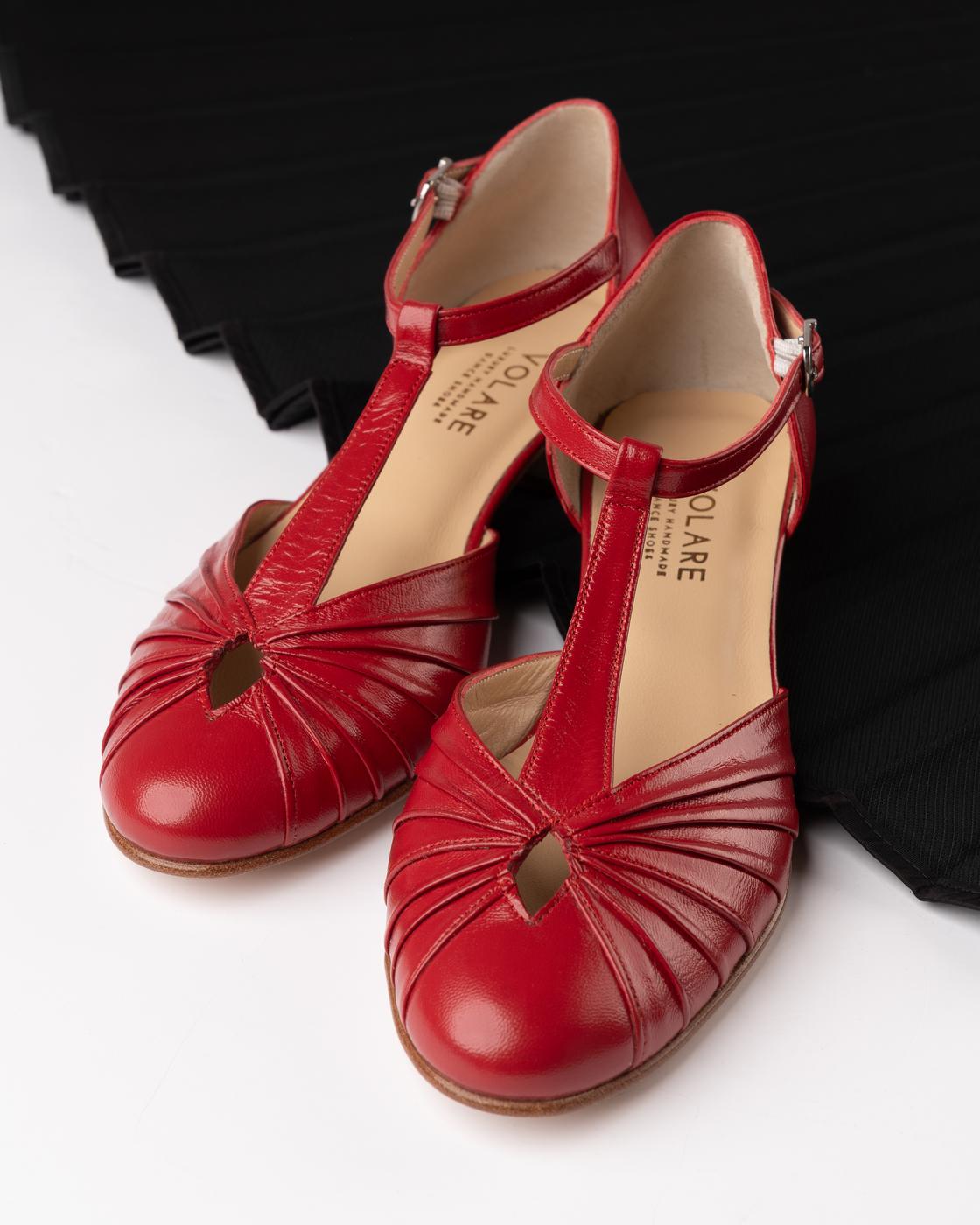 Red Volare T-strap shoes on white with black pleats
